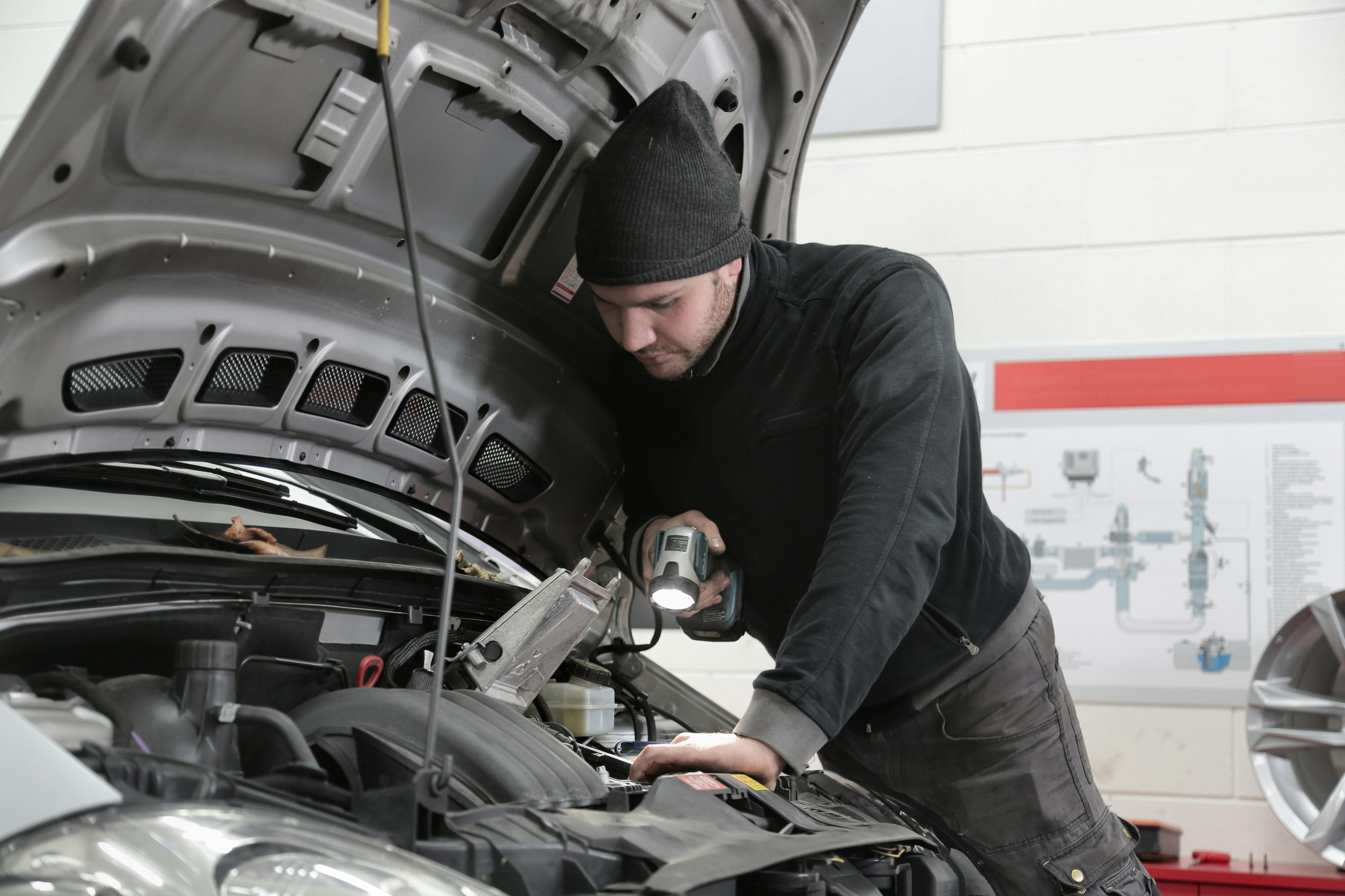 Man looking in car bonnet