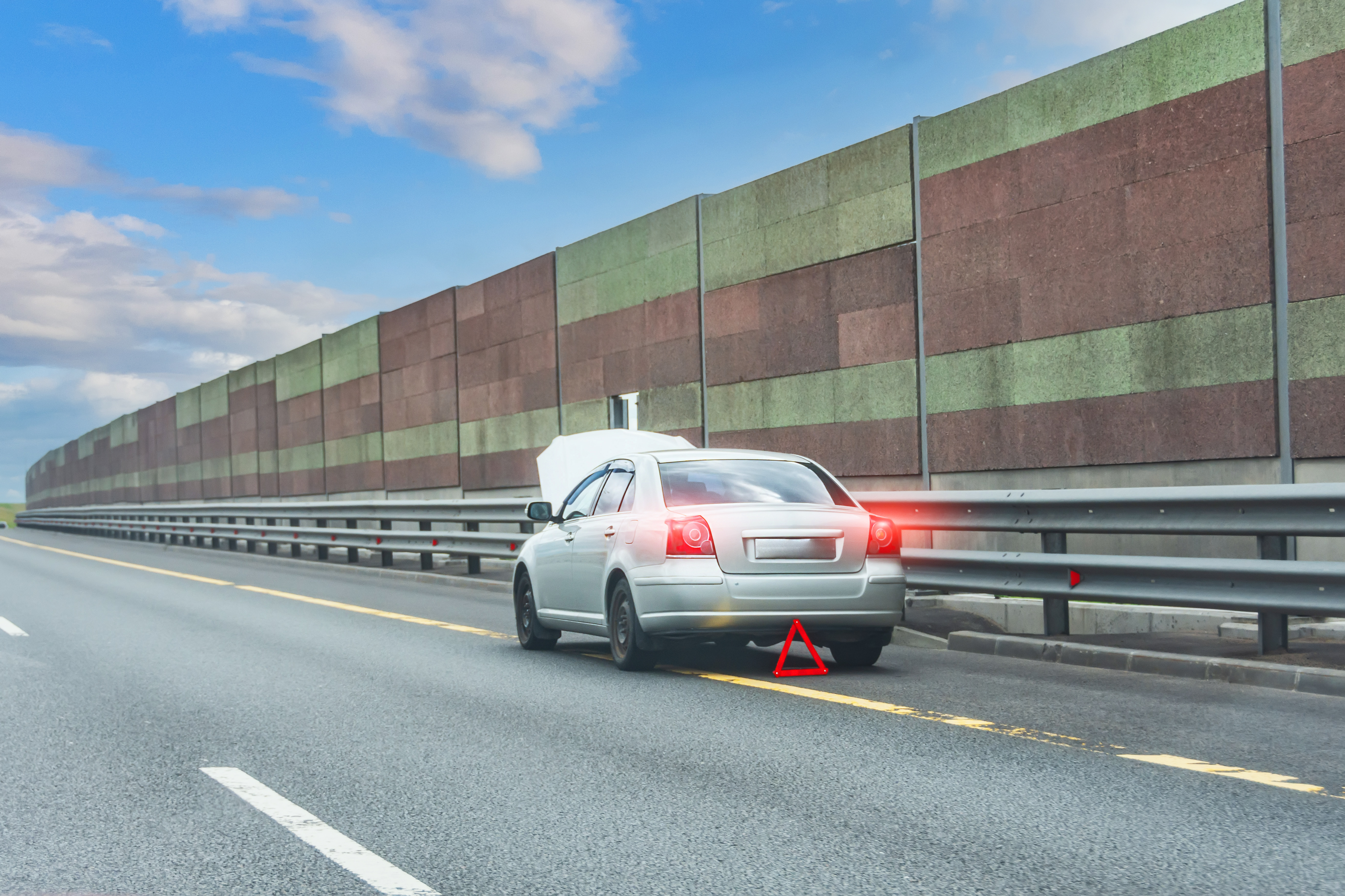 Broken down car on the side of an a road