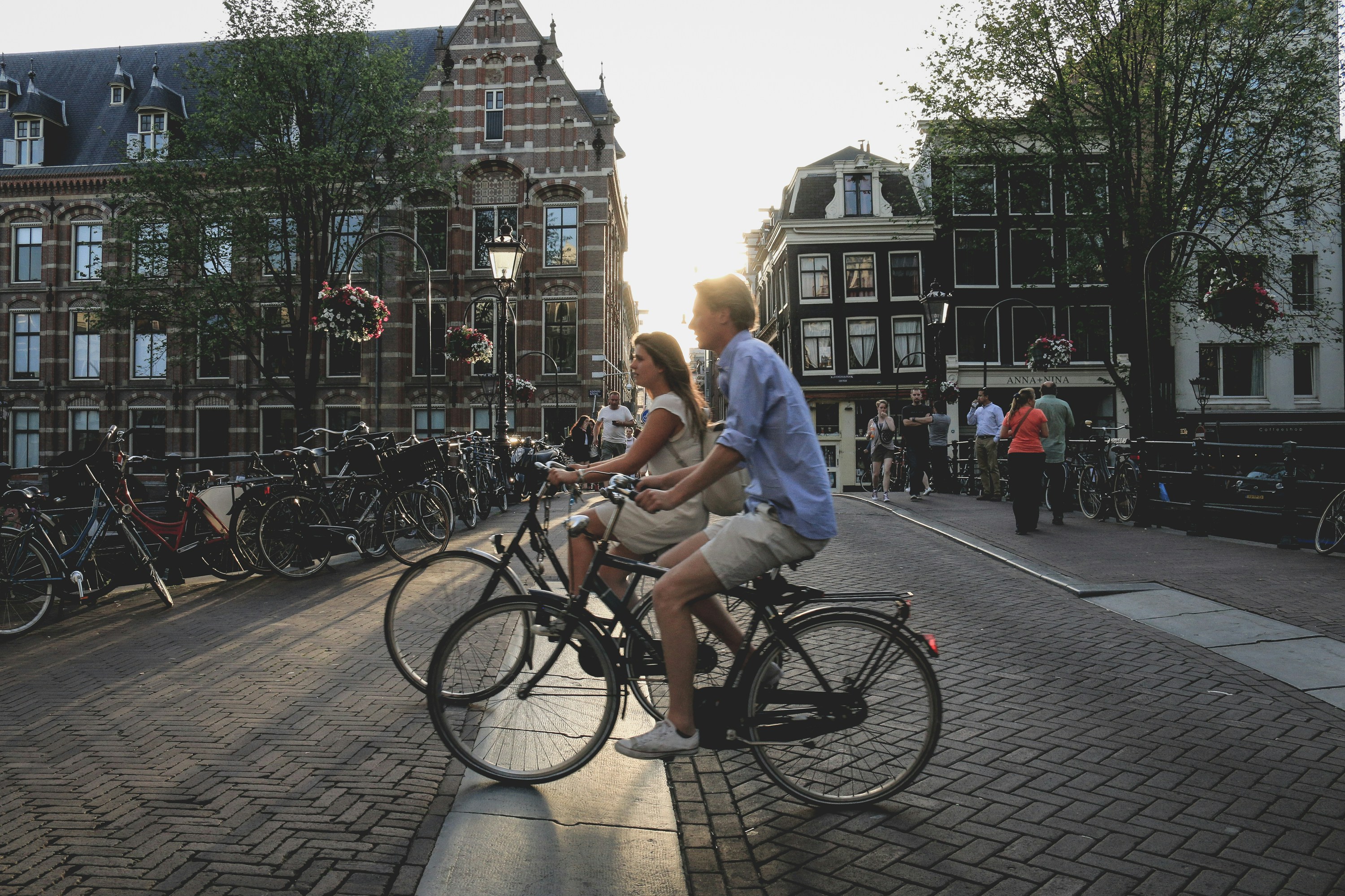 Two people cycling through Amsterdam