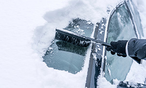 Clearing car of snow