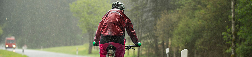 Man cycling in bad weather