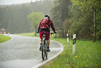 Man cycling in the rain