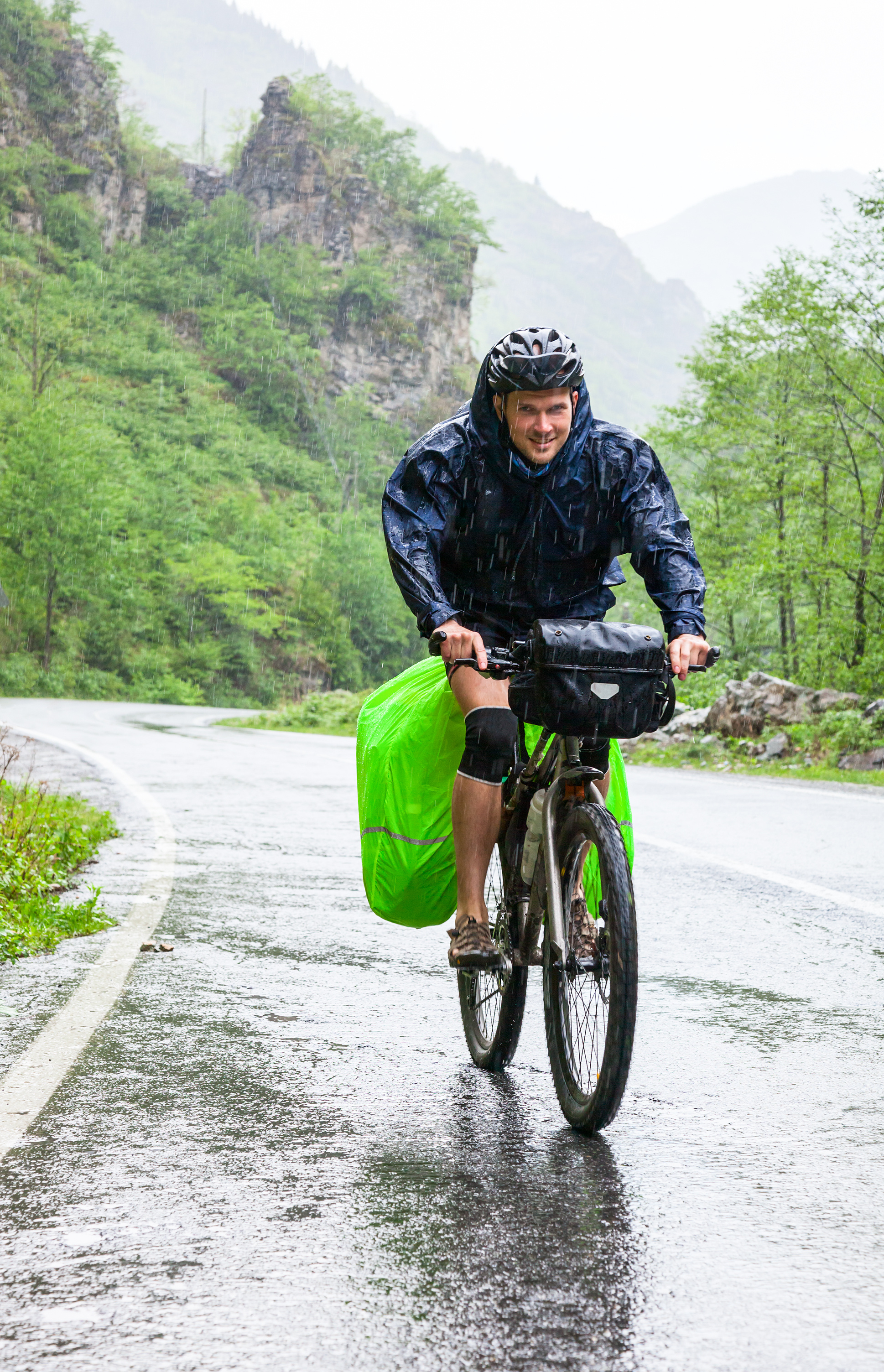 Man cycling in heavy rain