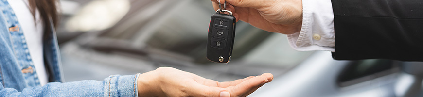 Two people exchanging car keys