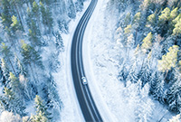 Car driving through snowy road birds eye view