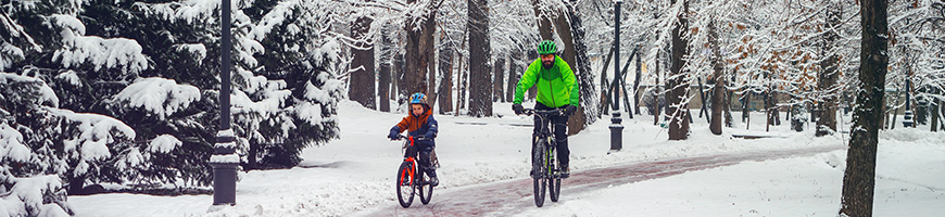 Father and son cycling in snow