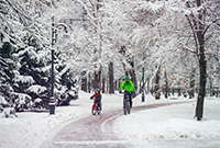 Father and son cycling through snow