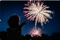 kid pointing at fireworks